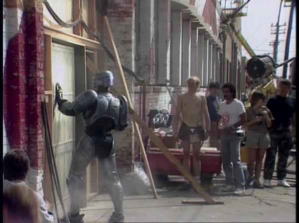 A behind the scenes photo from the filming of ROBOCOP (1987).