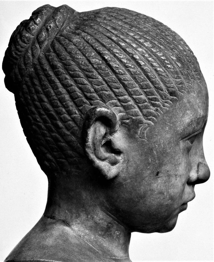 This striking portrait bust of a #Roman girl is in the @britishmuseum collection.  She sat for this portrait around 200-220AD & we know she had red hair as some of the pigment on the statue has survived. Her hair is divided into plaits, twisted into a knot on the back of the head
