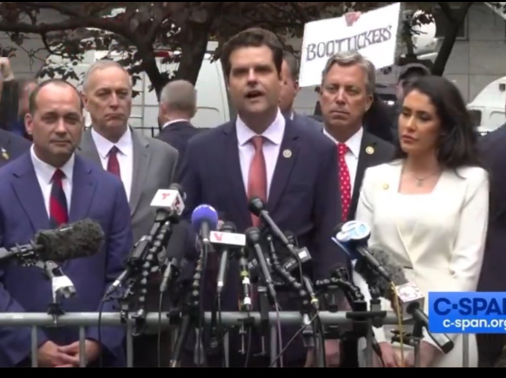 A “Bootlickers” sign appeared above Rep. @AndyOgles’ head outside Trump’s porn star affair (while his wife was pregnant) hush money trial today