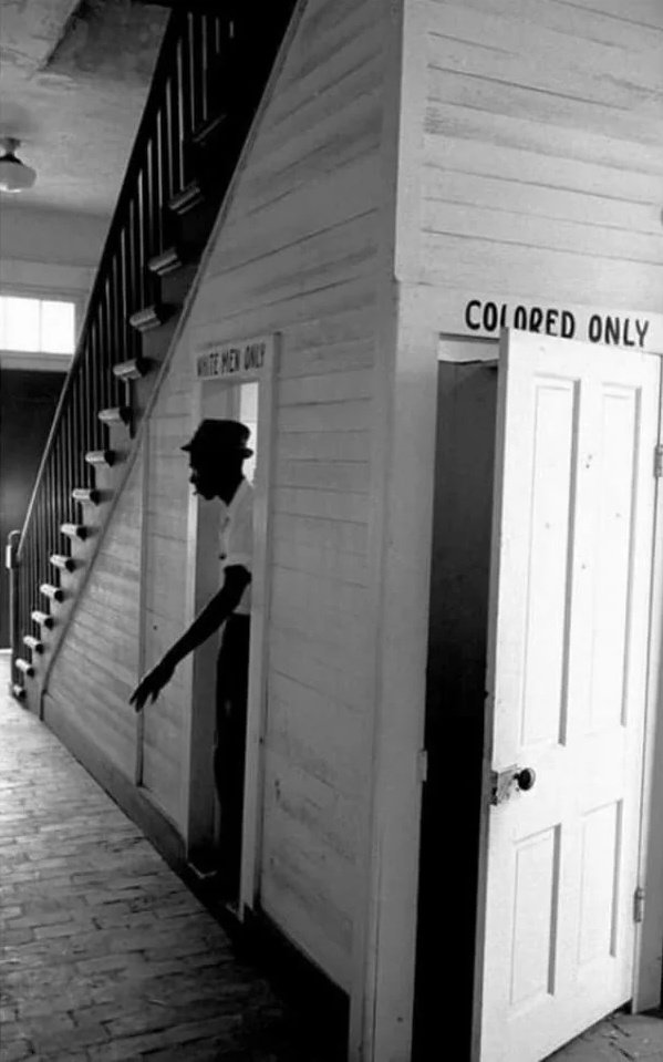 @fasc1nate An African American man emerges from a segregated bathroom at a courthouse in Clinton, Louisiana, in protest to segregation laws, 1964