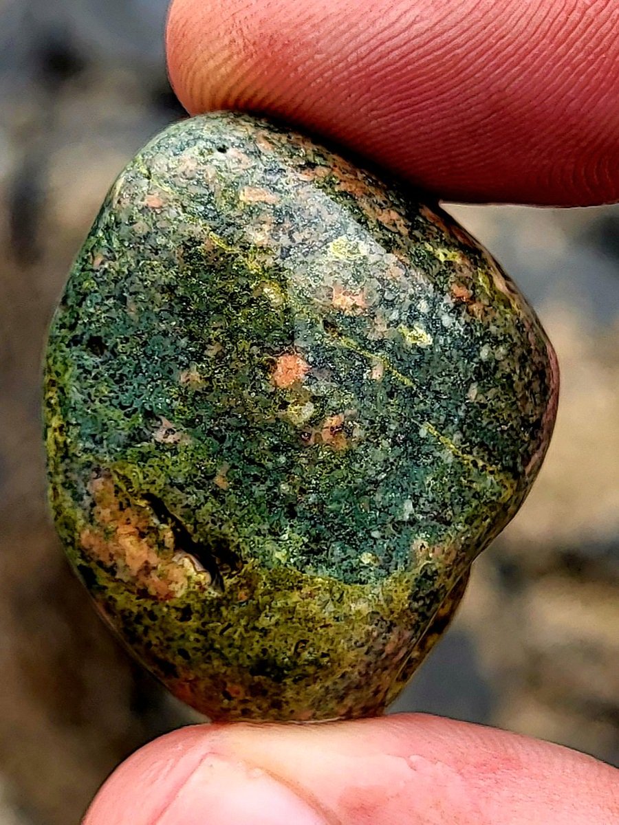 A pretty green pebble flecked with colours. County Clare, Ireland.