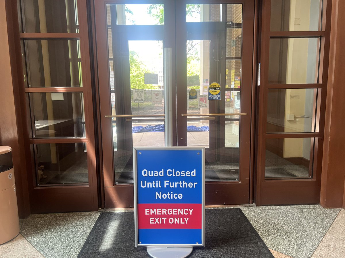 From inside the Richardson Library, the exit to the Quad has been closed off and there is a barricade outside the doors. @14eastmag