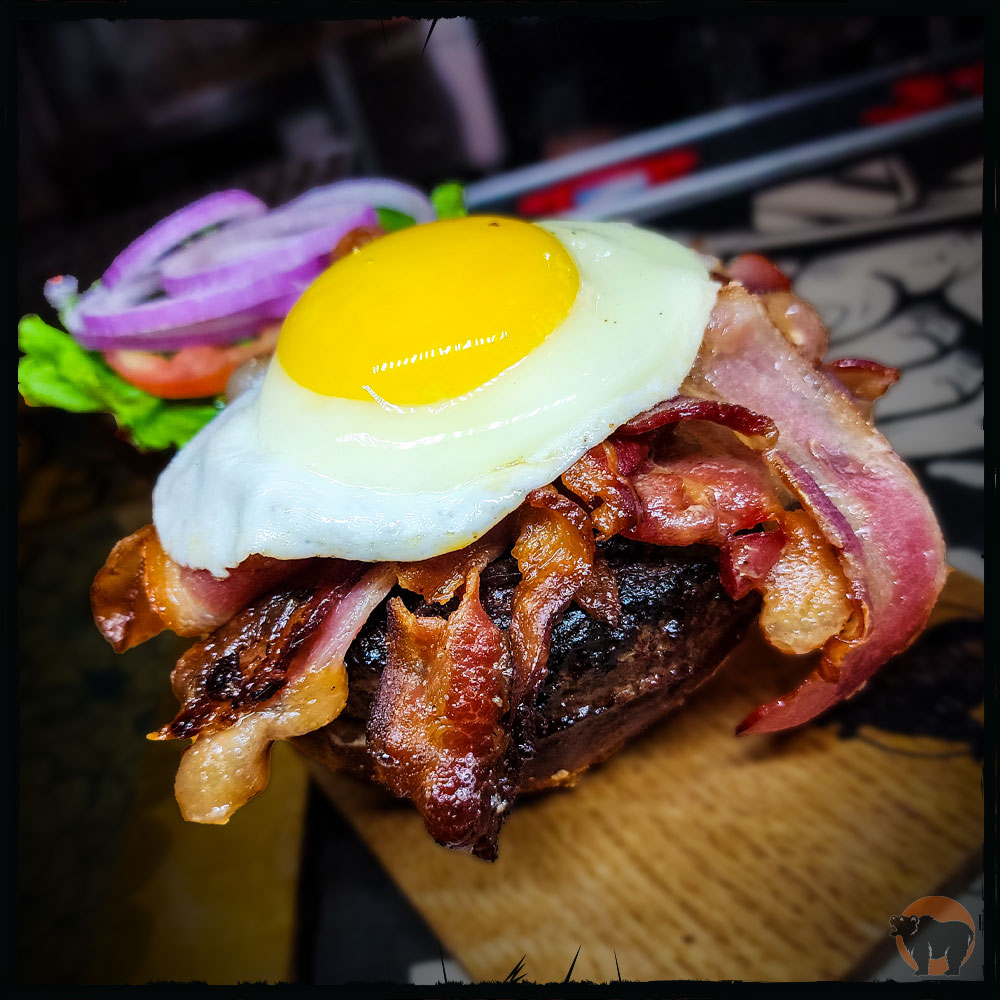 is the Gates of Slumber burger your new favorite burger? Kuma's Angus Beef Patty, (or choice of protein), 9oz of Applewood Smoked Bacon, Maple Syrup, Farm Fresh Fried Egg, Garlic Aioli, Lettuce, Tomato, Onion Available now at all Chicagoland locations