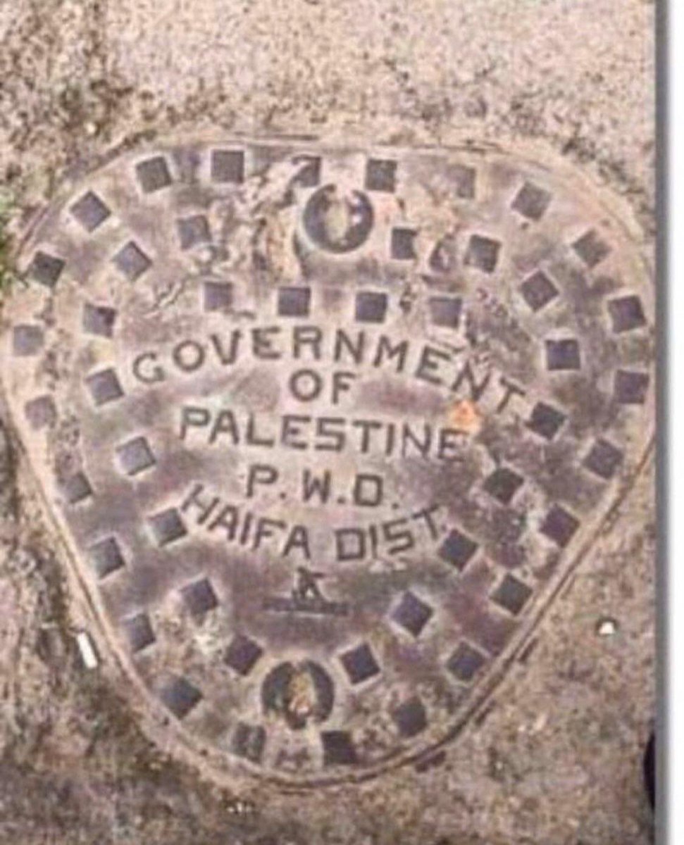 Iron man hole cover in Haifa manufactured by a Palestinian company in 1931 that says 'Government of Palestine'.