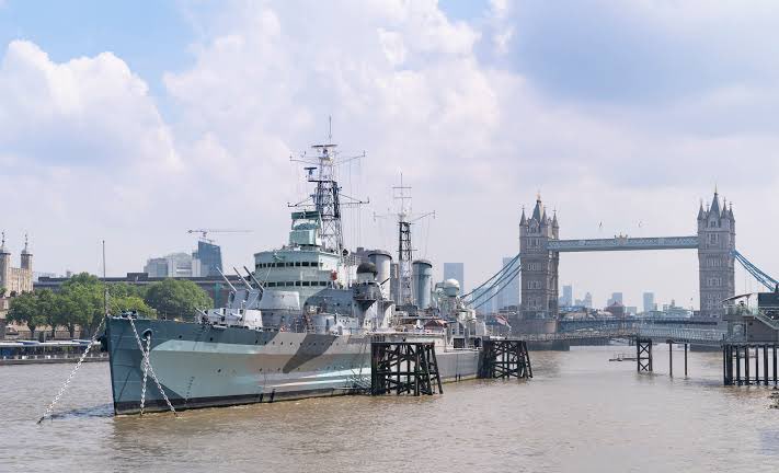 #RightPlaceWrongPerson #RM photo concept taken at Thames river bank outside the Custom House London.

🚢 behind is a Museum Ship 'HMS Belfast'. A town-class light cruiser that was built for the Royal Navy and now permanently moored as a museum ship on the River Thames.
