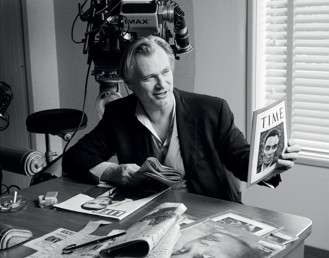 Christopher Nolan holds a re-creation of a 1948 Time cover, reworked by the props department to feature Cillian Murphy’s likeness rather than Oppenheimer’s.