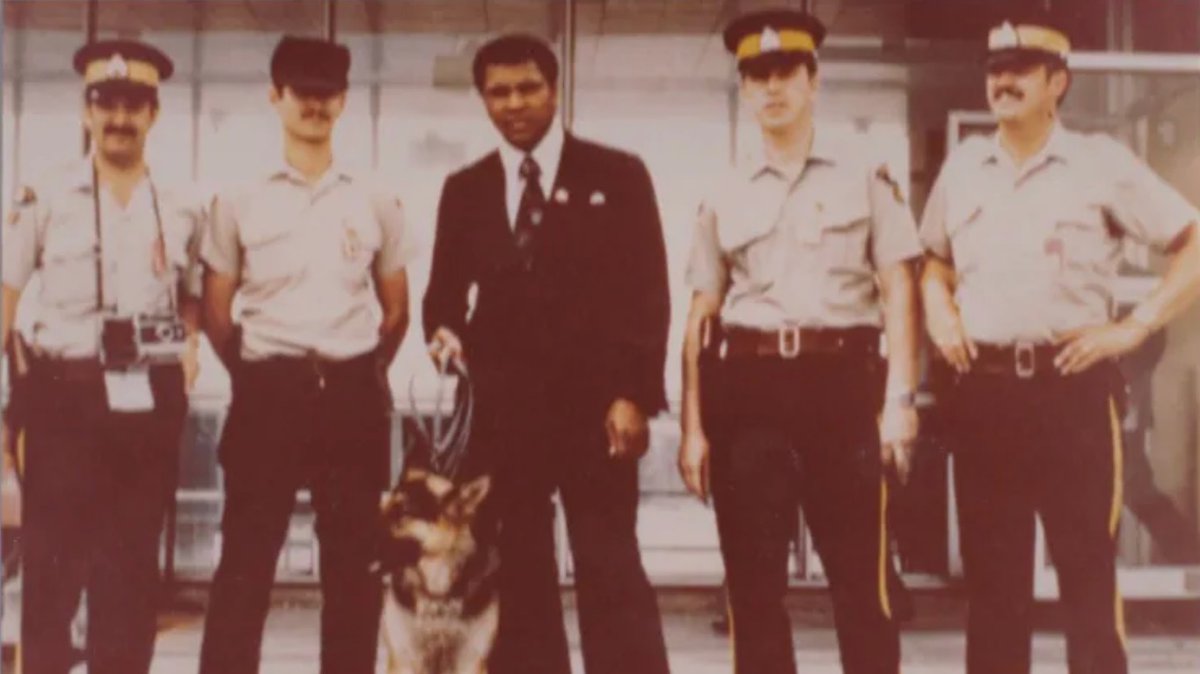 Muhammad Ali poses with RCMP officers & their dog during his stopover at Gander in 1978. The famous boxer being very friendly with the terminal staff, visited the RCMP detachment at the airport who asked for a photo as a memento of his visit