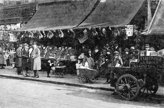 A bygone view of a Typical greengrocers shop in the early 1900s in London