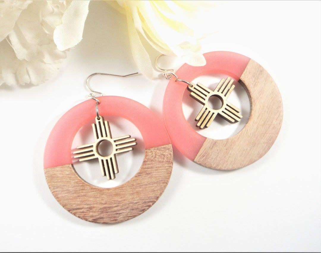 These large Zia earrings are made with lightweight resin and wood circle charms with 1 inch wood Zia Sun charms inside.  buff.ly/4aoxuiC #SantaFe #NewMexico #etsyshop #Albuquerque #etsyjewelry #shopsmall #wiseshopper