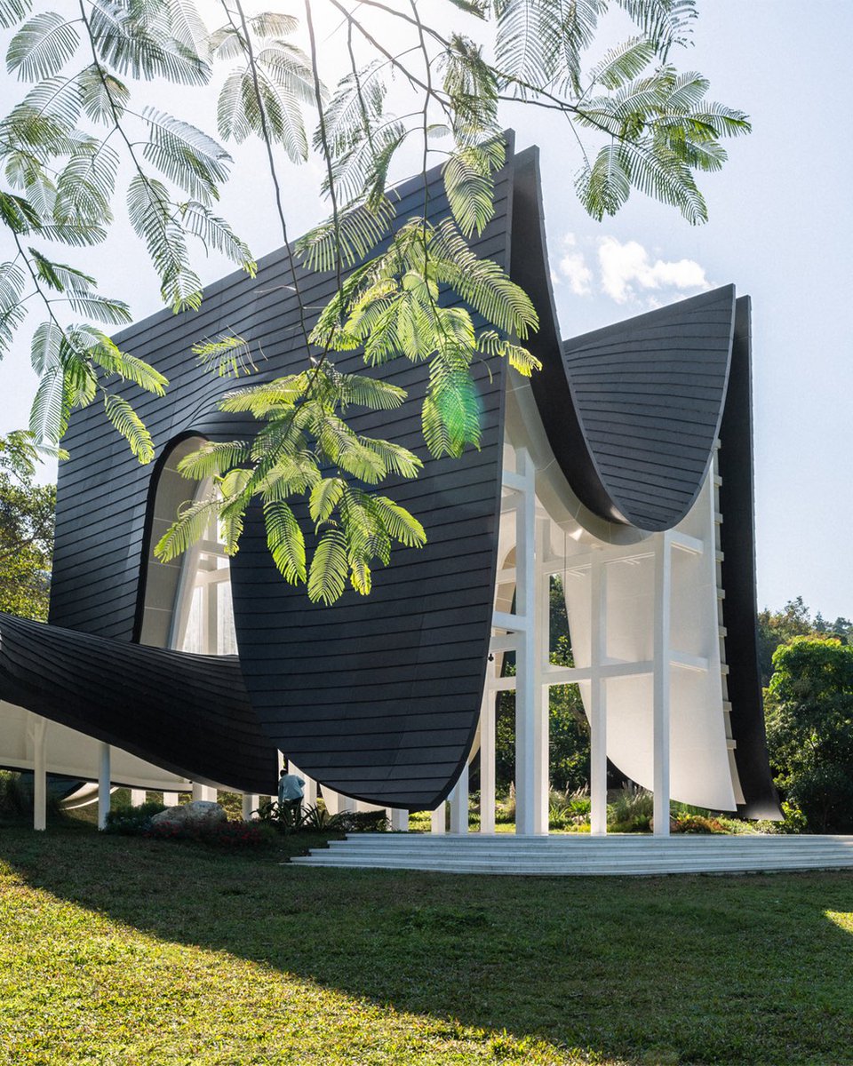 Xi Hall, designed by say architects, has a distinctive look in a forest resembling a levitated curtain. The iconic-looking building is used for public events, especially for wedding ceremonies. 

The design of the building is inspired by the Wok Room, a traditional residential