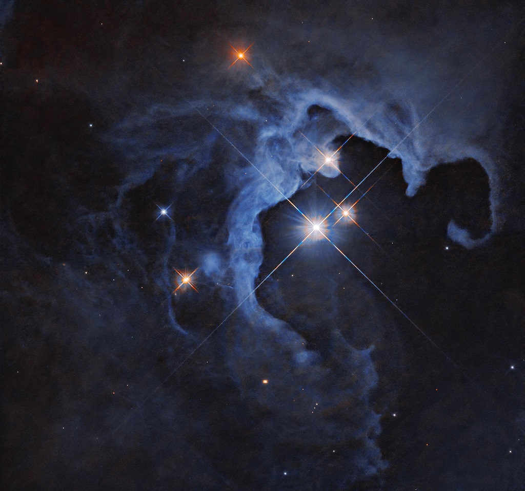 This fantastic image is Hubble's new artwork, released on 15 May 2024, which shows a bright triple star system surrounded by a blue reflection nebula.

HP Tau, the topmost and youngest one of the triangle (the other two are: HP Tau G2 and HP Tau G3), appears to be wrapped within