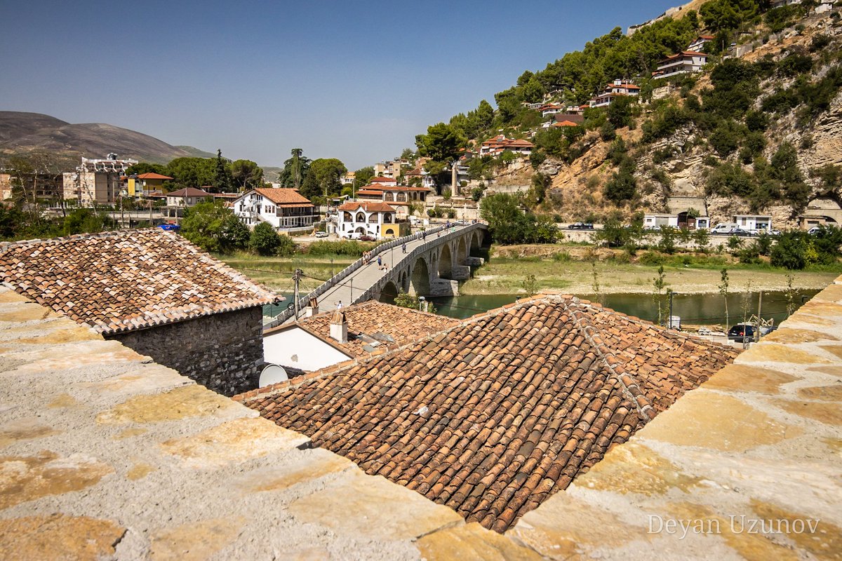Berat's Charm, a Glimpse into Albania's Rich History Behold the timeless beauty of Berat, Albania! Nestled along the Ishull River, the historic Gorica Bridge stands as a testament to the city's rich cultural heritage.