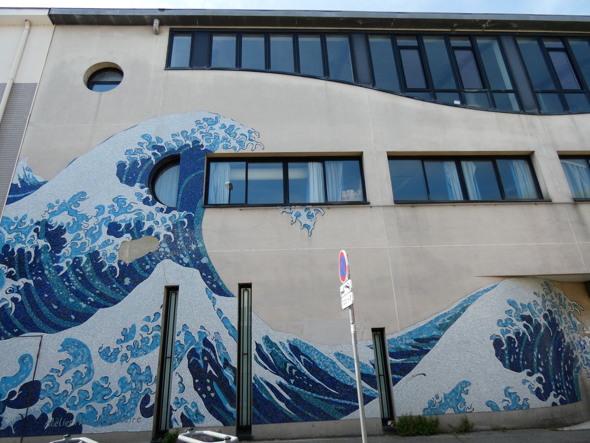 On the #facade of a #cultural #edifice, #Hokusai's #GreatWave has landed in #mosaic. The blue sky reflected in the #glass, A #harmonious, #timeless, merging mass. 📷 Paris SB #Architecture #architects #design #architecturephotography #StreetPhotography #葛飾北斎 #建築 #設計 #街