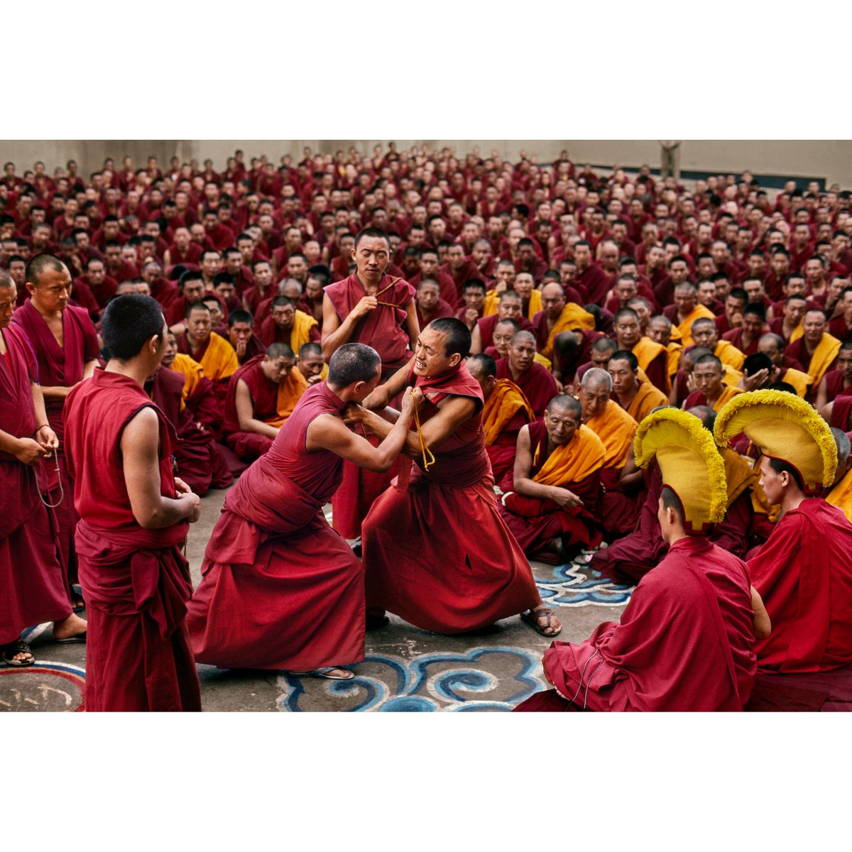 Tibetan Monks fiercely debate the nature of reality with humor and passion. In Tibetan Buddhism, debate is considered an integral part of sharpening one's analytical capabilities and demonstrating one's understanding of Buddhist logic and philosophy. Sakya Monastery, Bylakuppe.