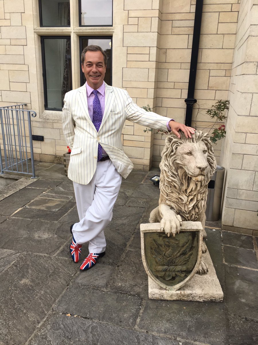 GusTheFox's tweet photo. Nigel Farage as a Victorian ice-cream cart owner who exclusively sells Rohypnol flavoured ice cream.
He’s dressed like such a cunt here that he’s made a stone lion turn away in embarrassment. https://t.co/tz8yxk7GkS