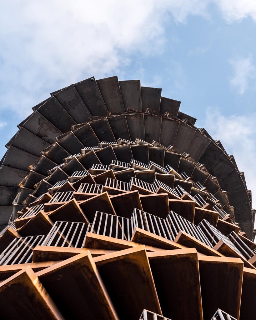 parametricarch's tweet photo. Marsk Tower, designed by @BIG_Architects, appears as a sculptural art object rising 25 meters high from the landscape. It functions as an observation lookout and a key tourist landmark in Denmark.

The immense swirling staircase, made from corten steel, creates a distinctive feature in the Wadden Sea National Park. The stairs widen at the top of the tower, forming a 110-square-meter lookout point with views extending to the city of Esbjerg, the islands of Rømø and Sylt, and beyond the Wadden Sea to the North Sea.

📸 Rasmus Hjortshoj

#parametricarchitecture #parametricdesign #observationtower #denmark #marsktower