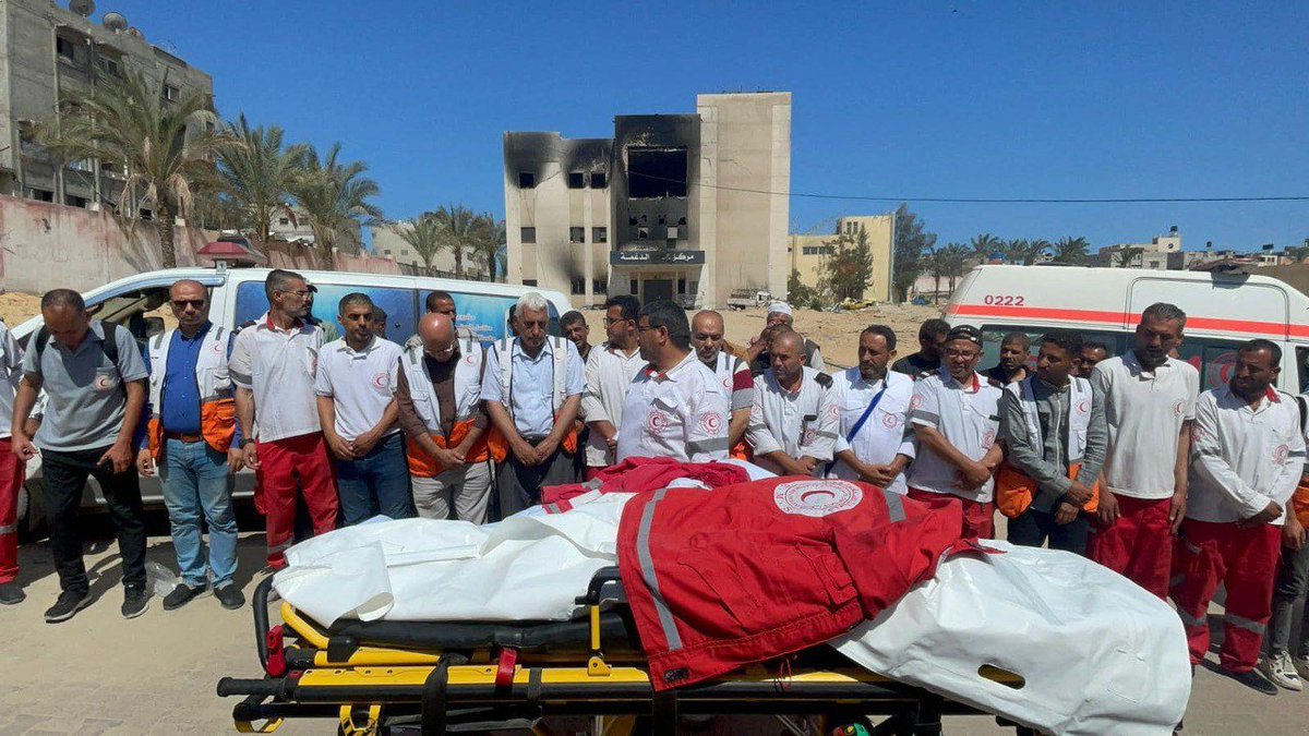 Palestinian Red Crescent paramedics mourn two of their colleagues, Haitham Tubasi and Suhail Hassouna, killed last night after being targeted by an Israeli airstrike while on a humanitarian mission in the Tel Sultan area, west of Rafah.