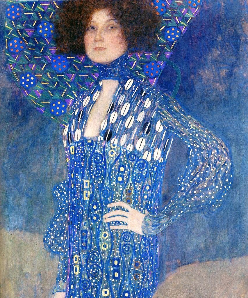 Gustav Klimt painting dress designer and muse Emilie  Flöge creations.   Gold leaf was used prolifically!