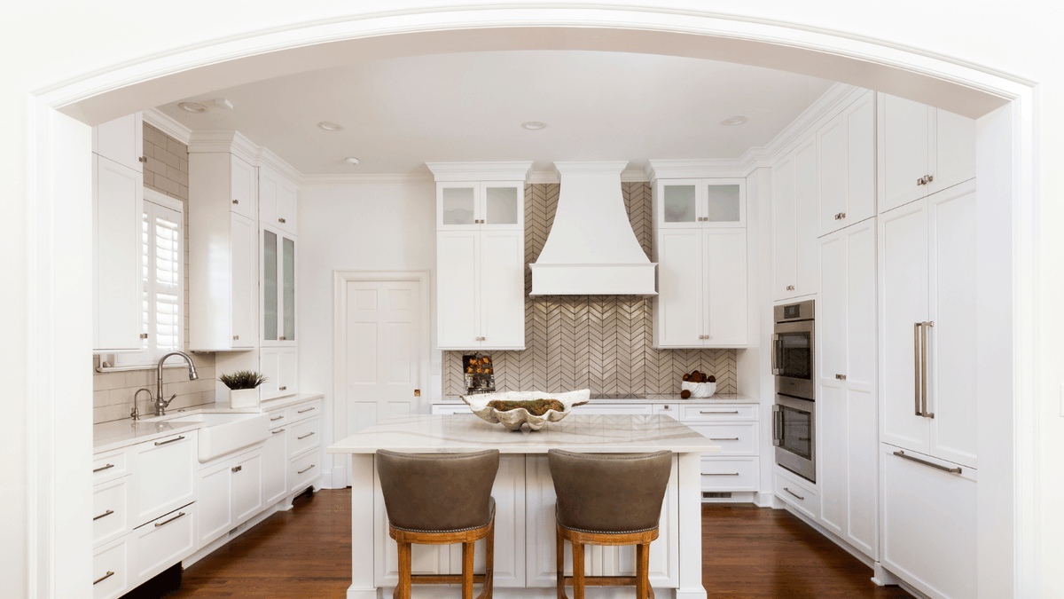KettlerDesign's tweet photo. The arched entrance frames this kitchen for a shadowbox effect, so you feel like you’re walking into a piece of art. 📸 by Jim Schmid ☀️ Touchstone Fine Cabinetry ☀️ @CambriaSurfaces ☀️ @walkerzanger tile
#whitekitchen  #karenkettlerdesign https://t.co/JDmF0PHEhS