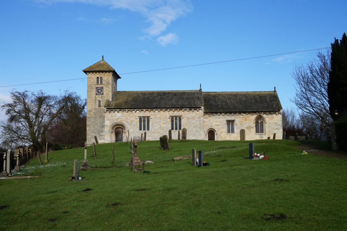 St John the Baptist Church is situated near York and Tadcaster.  It was originally dedicated to Saint Helen, the church's chancel and south door date from around 1150 whilst the north aisle and door were added in the late 12th with various alterations following in the 15th.