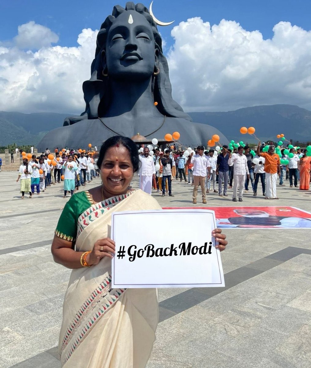 Amusing, that the woman stands with “Go Back Modi” placard in front of Sadhguru’s Ashram. 🤡🤡🤡