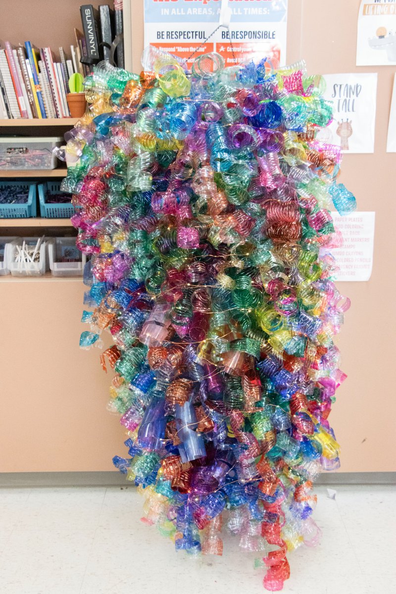 AllianceCSD's tweet photo. The art classes at Alliance Intermediate School created a chandelier from 1044 plastic water bottles! The students collected, cut and colored the water bottles to create the work of art that will soon hang in the AIS cafeteria.  Great job, AIS! #RepthatA https://t.co/IjWr3TXImx