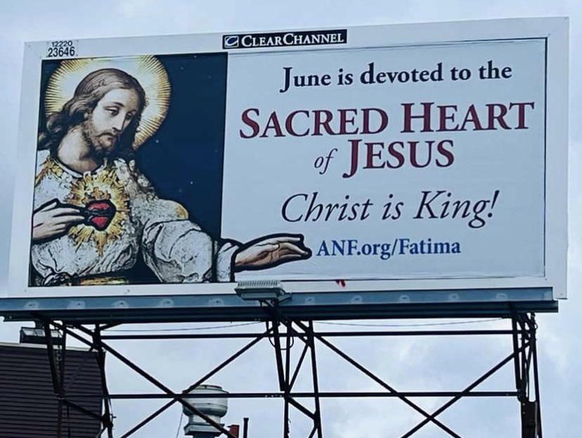 The month of June is dedicated to the Sacred Heart of Jesus! A reminder billboard in Somerville, Massachusetts. Image and source: Robert G. O’Brien