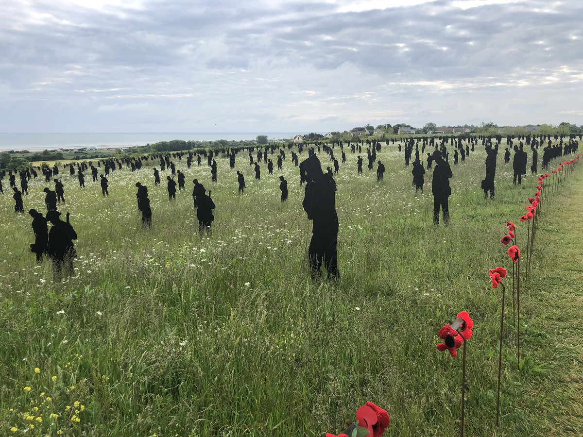 britishmemorial's tweet photo. With less than a week to go to #DDay80, our 1,475 giants stand, heads bowed, among the growing wild meadows around the Memorial. Hand-knitted poppies alongside the fallen.

#StandingWithGiants

Credit - @authorAPT https://t.co/dfOnNRzsa9