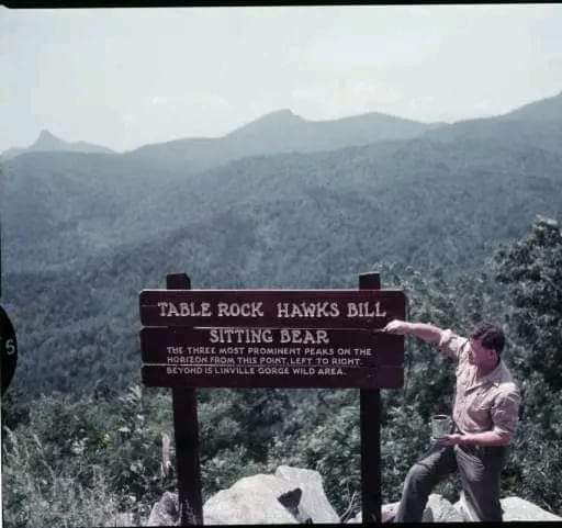 **LINVILLE GORGE, NORTH CAROLINA** Boy Scout leader and seasonal Blue Ridge Parkway ranger Clyde Smith painting one of his signs for mountain overlook at Linville Gorge, NC reading 'Table Rock,