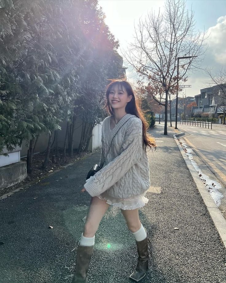 In a world where every street sings its own song and every tree whispers tales of old, there walks a girl named Chuu Kim. Her presence is a melody in the cacophony of everyday life, a symphony of light and warmth that dances through the cold embrace of winter.