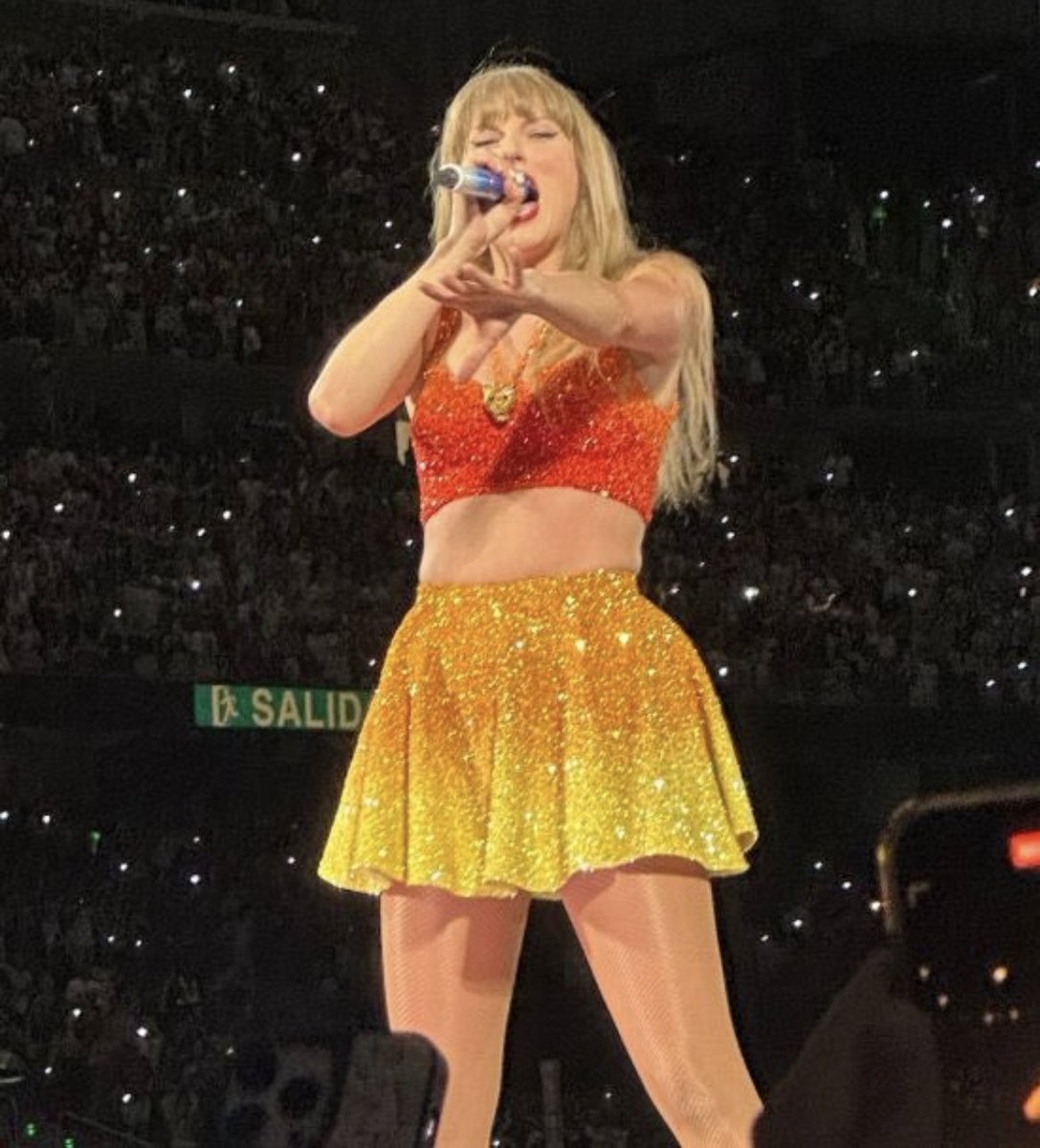 TrollFootball's tweet photo. Taylor Swift wearing Barca colours at the Santiago Bernabeu https://t.co/PhPzMu19ml