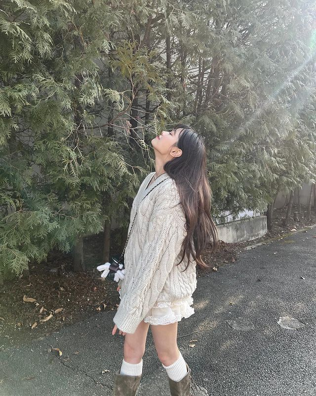 In the photograph that captures her essence, she strides with an elegance that transcends the mundane, her smile a beacon of joy in a world that often forgets to look up and notice the beauty in the simple things.