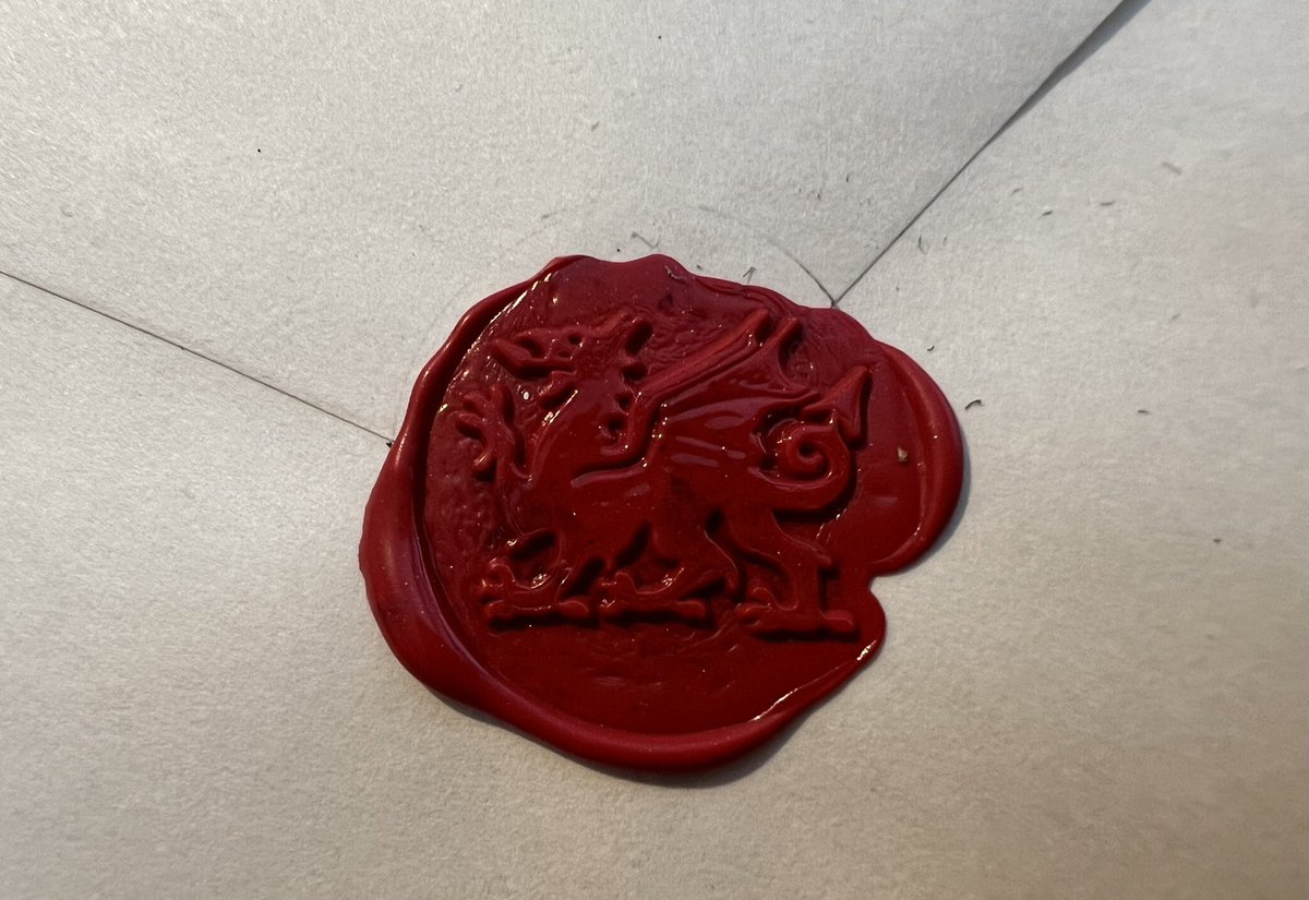 Painted Pwlldu on an envelope With a postcard of Pwlldu, Gower. Sealed with a Welsh Dragon