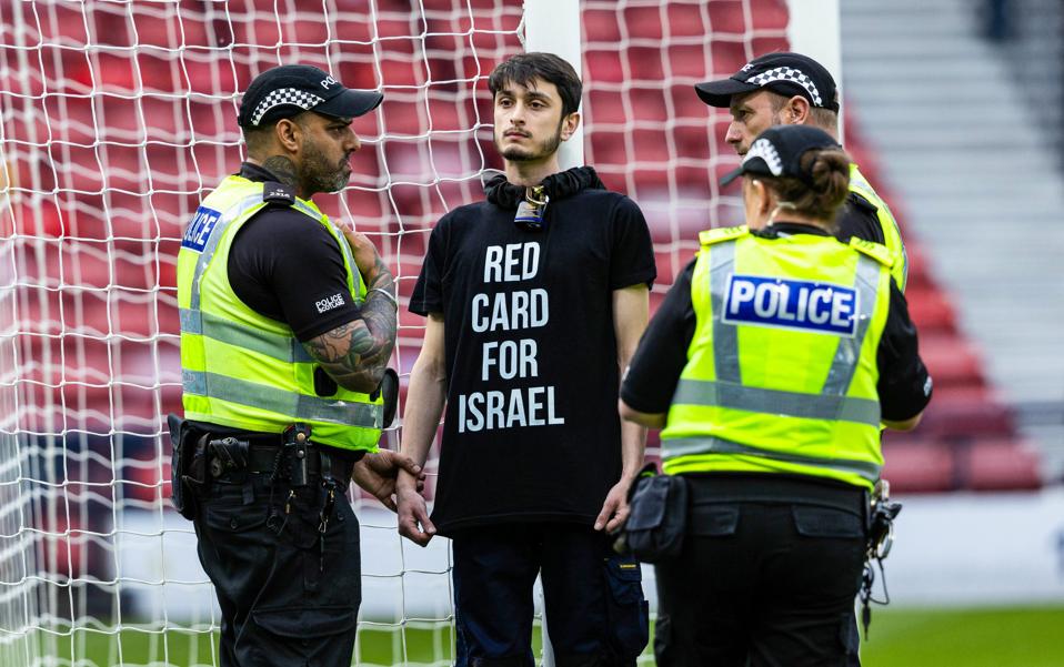 Asif Burhan (@asifburhan) on Twitter photo The <a href="/WEURO/">WEURO 2025</a> match between Scotland and Israel at Hampden Park has been delayed after a man wearing a 'Red Card for Israel' T-shirt locked himself to the goalposts (Photo: Craig Foy) #SCOISR The <a href="/WEURO/">WEURO 2025</a> match between Scotland and Israel at Hampden Park has been delayed after a man wearing a 'Red Card for Israel' T-shirt locked himself to the goalposts (Photo: Craig Foy) #SCOISR