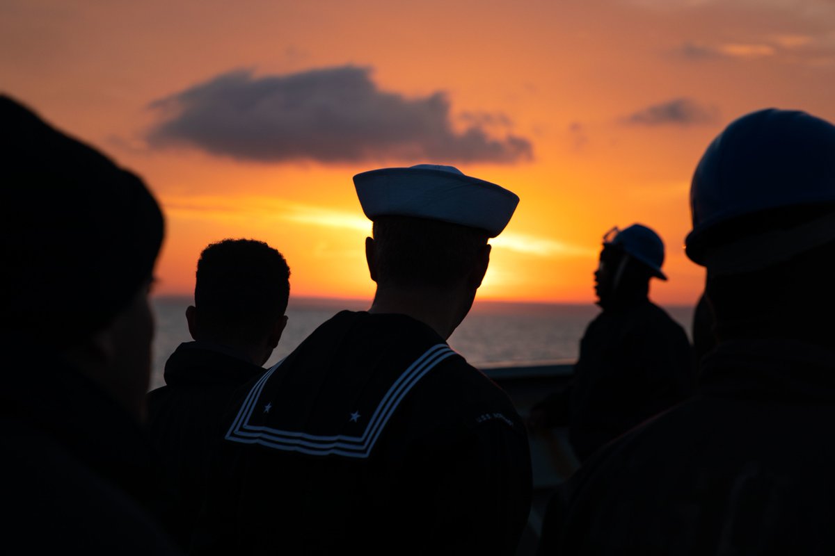 Fire Controlman 3rd Class Blackaby Kulpa, center, musters as part of the sea and anchor detail on USS Normandy as the ship pulls into its namesake region in France underway with the Gerald R. Ford Carrier Strike Group, Nov. 14, 2022. (U.S. Navy photo by Mass Communication