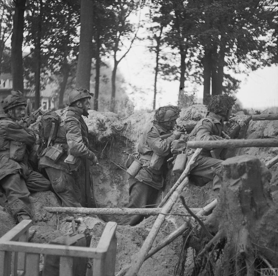 Troops of the 1st Paratroop Battalion take cover in a shell hole in Arnhem, 17 September 1944. See more photos from Operation Market Garden on our website: bit.ly/3Es8Pw9 IWM (BU 1167)