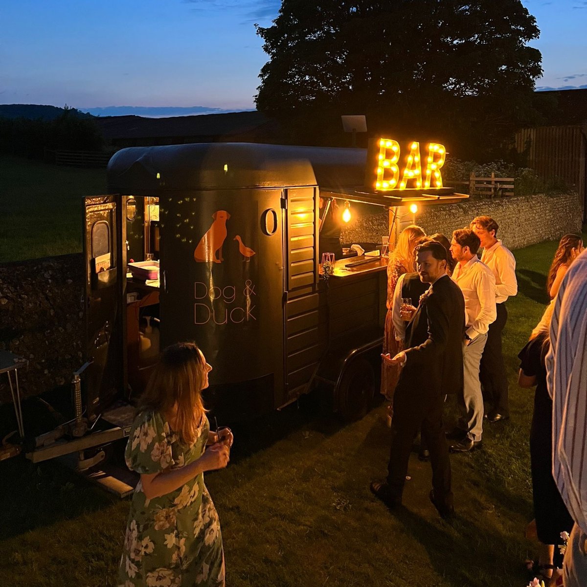 The Dog &amp; Duck looking stunning at dusk. The backlight bar and light up sign, make it the perfect centre point for any evening event... serving up cocktails, coffees or local beers to your VIP guests - from weddings to music festivals. 🍸

#VIPbar #MobileCocktailBar #FestivalBars