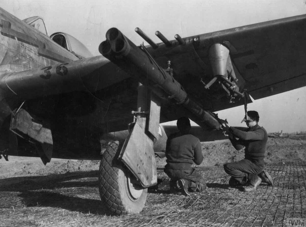 Ground personnel of the 324th Fighter Group, 12th Air Force fit Bazooka tubes onto the wing of a P-47 Thunderbolt. Watch our video on the Thunderbolt: bit.ly/3Ku3c3b © IWM (FRE 10972)