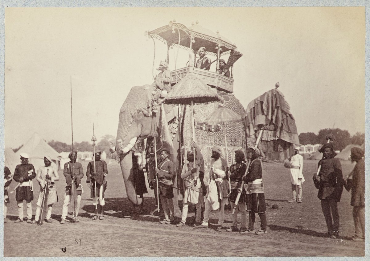 Maharaja of Orchha riding the state elephant, with his retainers and other servants, 1875