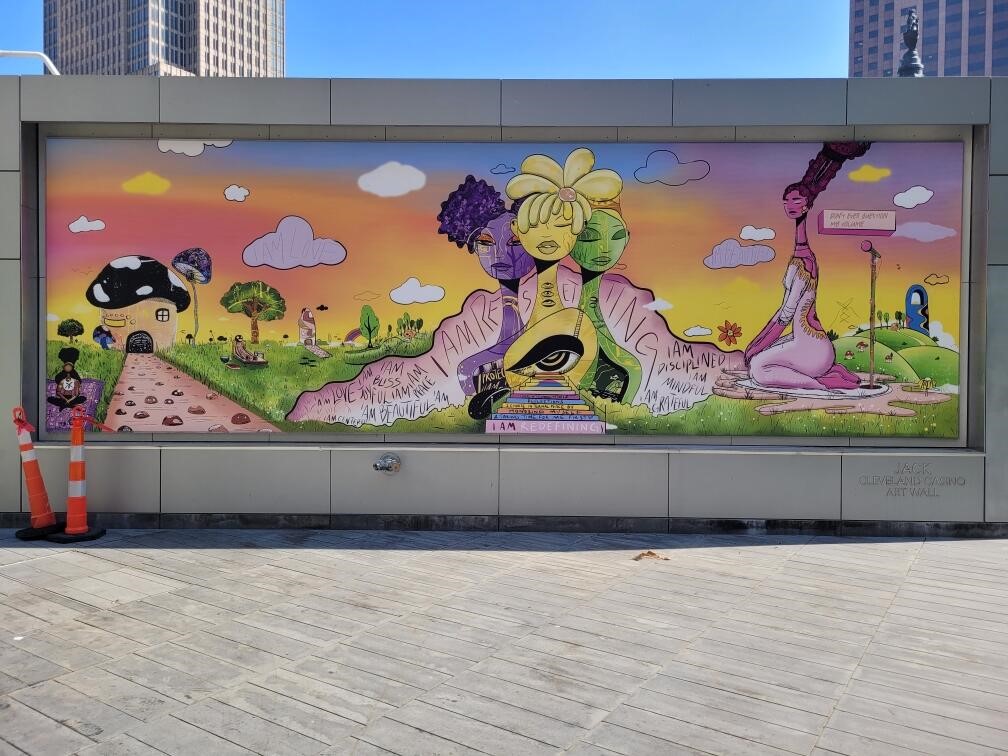 Go see this latest installation "I Am Resetting", at the <a href="/JACKCleCasino/">JACK Cleveland</a> Cafe Art Wall at Rebol on #CLEPublicSquare by local talent, Lacy Talley <a href="/Lacerrrr/">Lacy Lace 🪩💖</a>, as part of #LandformCLE. #Murals #ThisIsCLE #ColorAndVibrancy #PublicArt #WomenInPublicArt #Reset #MakersMarkArtandSoulCLE
