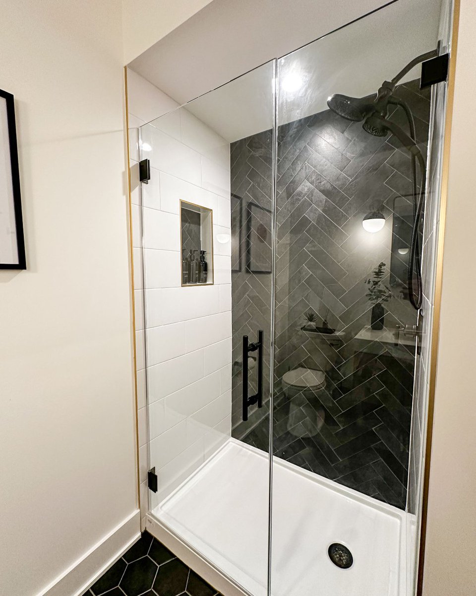SEIConstruction's tweet photo. Revamped and refined ✨ Loving our latest bathroom reno project. It's the perfect blend of mid-century and transitional design. The black and white tile shower, light oak vanity with marble-inspired quartz, and sleek black hexagon floor create a timeless, sophisticated space. 🖤 https://t.co/HS6yFgfZ5x