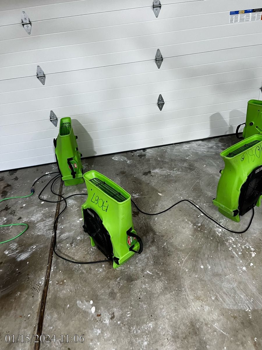 Air movers drying garage ceiling after ice storm.