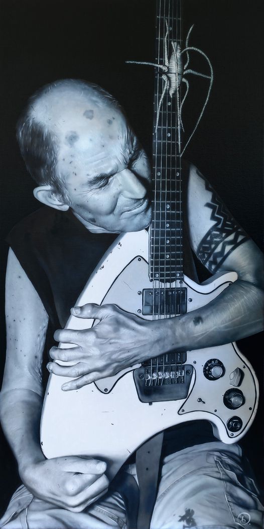 This is Adam Portraiture Award finalist Dita Angeles' oil painting 'It's Love'. 'Over a decade after a life-changing stroke, Chris Knox is larger than life in a deeply nostalgic moment, embracing his decommissioned guitar like a beloved old friend.' 
It's one of 37 finalists...