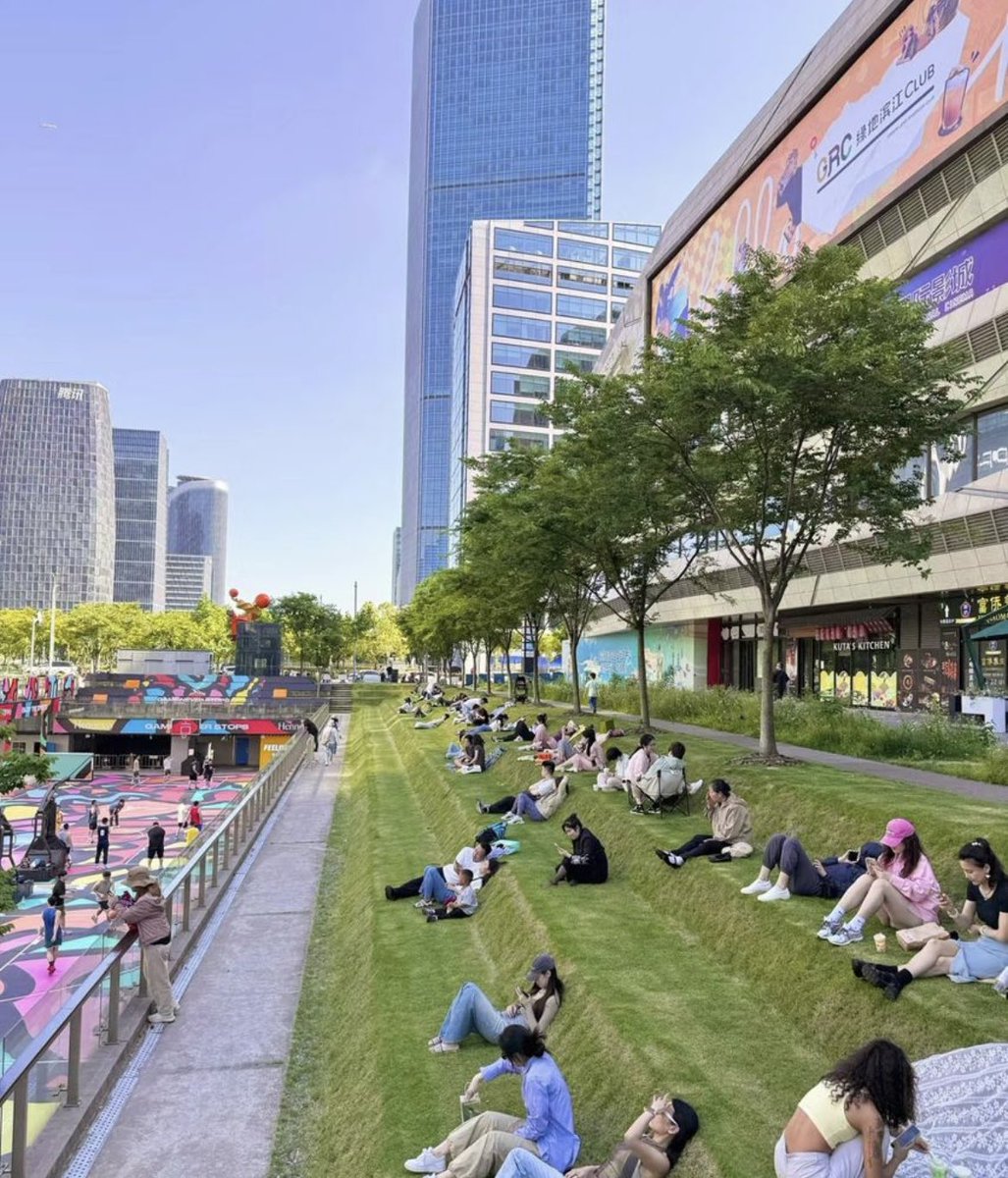thinking about how perfect this urbanscape in Shanghai is:

- tiered lawn with ergonomics to support lounging and naps without it being awkward
- positioned right below trees for shade
- overseeing a plaza where people dance and exercise for maximal people-watching capabilities