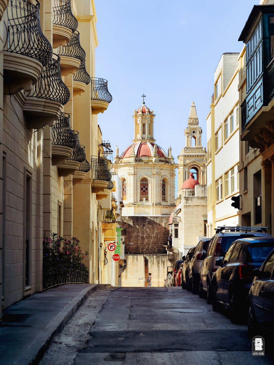 A view down Church Str #Sliema with the dome of Sacro Cuor church towering in the distance. During World War II this large church was heavily damaged and the Franciscan friary nearby completely destroyed leaving a Franciscan Father and others for dead, buried under the rubble