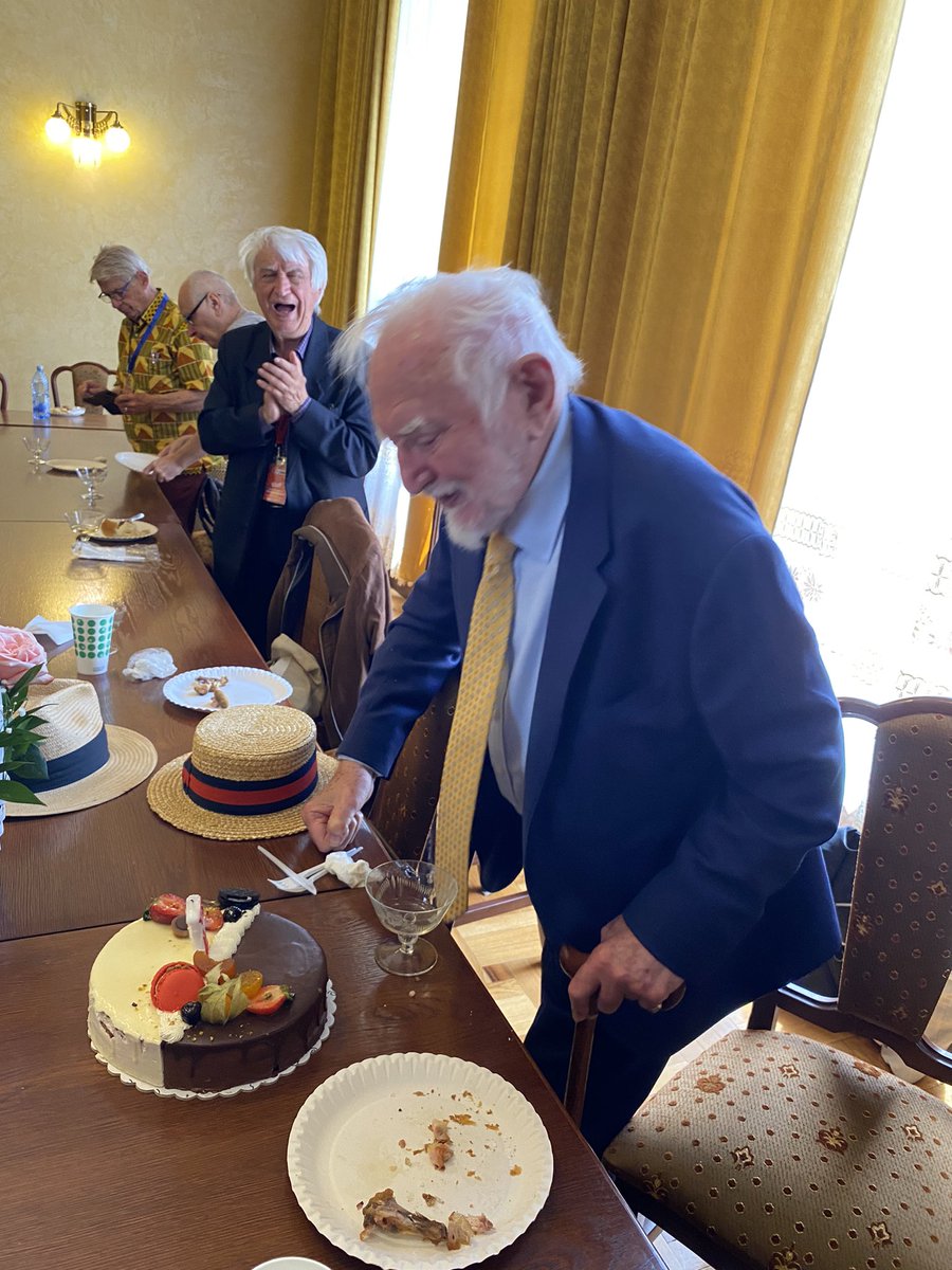 Paul_Edmondson's tweet photo. Cutting his cake! Happy Birthday @stanley_wells at The Craiova Shakespeare Festival, Rumania, &amp; being interviewed for the Festival's documentary for national television. @ShakespeareBT @BSAShakespeare https://t.co/Zcq4piwhYb