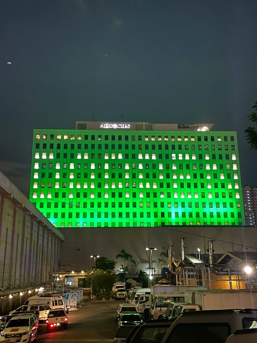 ABSCBNNews's tweet photo. LOOK: The facade of the ABS-CBN ELJCC building is lit in green, spelling out "DARREN," as the singer-host @Espanto2001 announces his 10th anniversary concert set this June 1. | via @anjo_bagaoisan https://t.co/ql7efKXdDQ