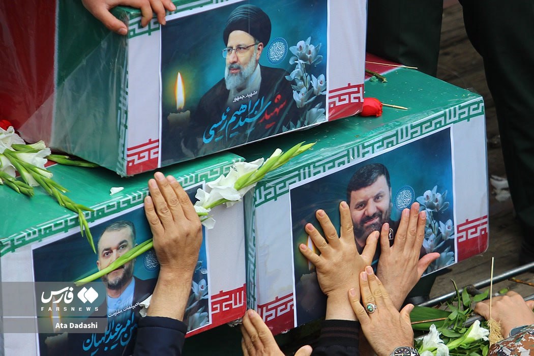 The coffins of: President Ebrahim Raisi (top) Foreign Minister Hossein Amir-Abdollahian (bottom left) Head of president's security Seyed Mehdi Mousavi (bottom right)