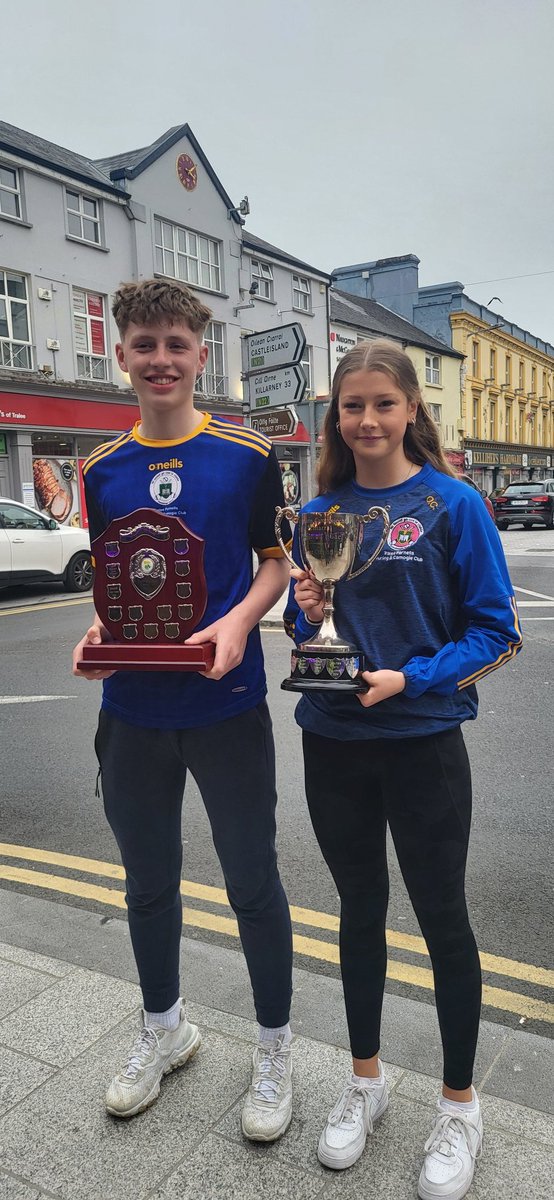 TParnells's tweet photo. Our Feile-winning captains, Daniel Spring &amp; Orla Costello, with the Division 1 county feile trophies. Fundraising is ongoing for both teams as they prepare to travel to Wexford for the National Feile competition. Your support is greatly appreciated
 https://t.co/yPXX88tXFN https://t.co/3xwHxf7NQ7