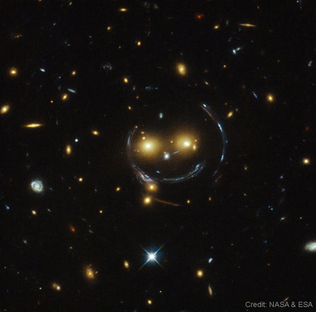 Galaxy cluster SDSS J1038+4849 might be smiling because it knows that telescopes can’t directly see dark matter, but they help us figure out more about it thanks to gravitational lensing. And that’s the tea! Learn more here: go.nasa.gov/4aCTYNi